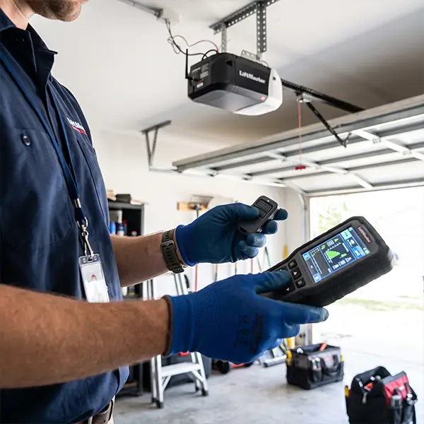 Technician repairing a garage door opener in Carrollton TX